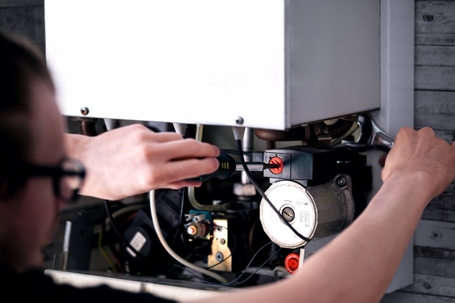 Technician inspecting heating system.
