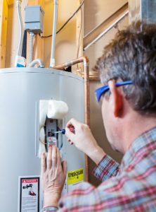  A man fixing a water heater